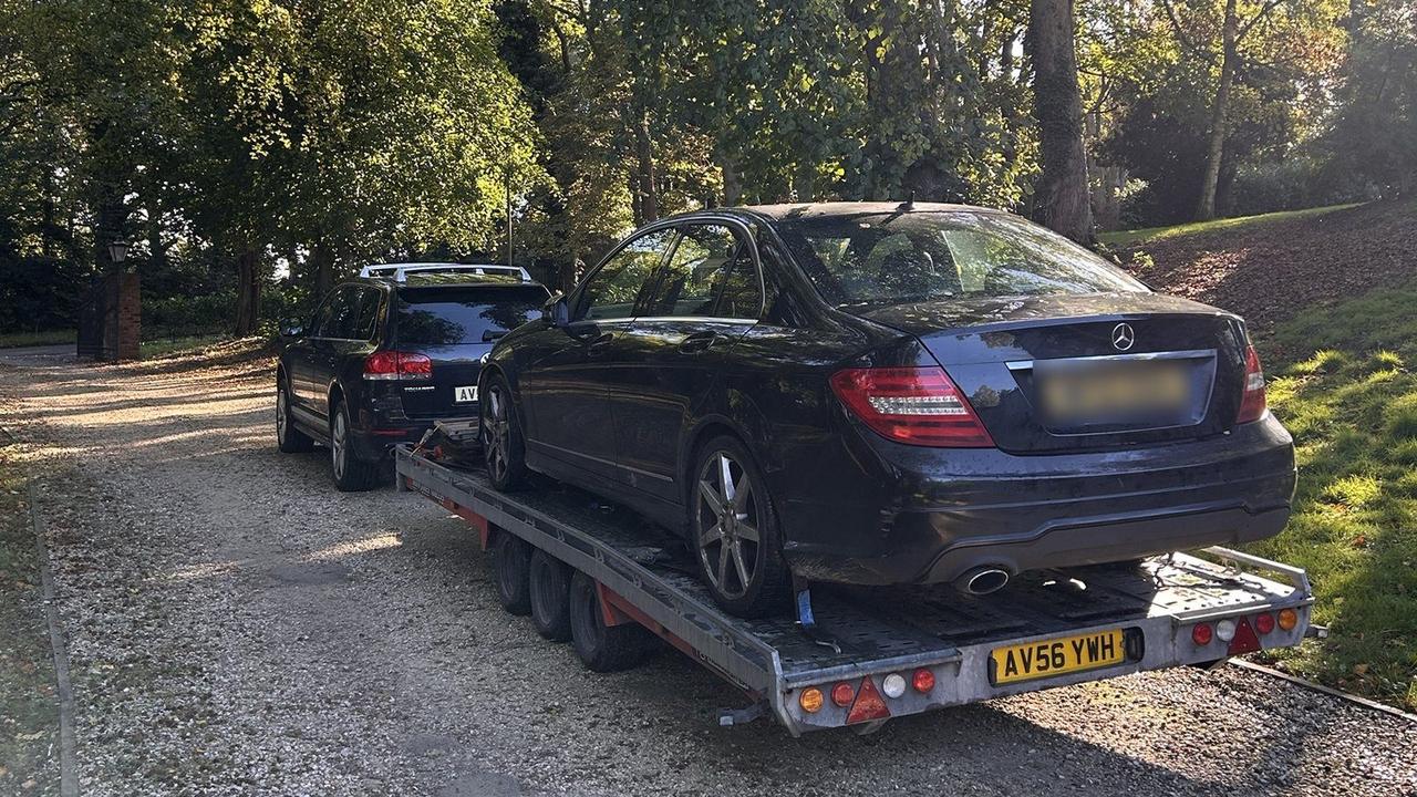 Mercedes C-Class on the trailer on a tree-lined drive