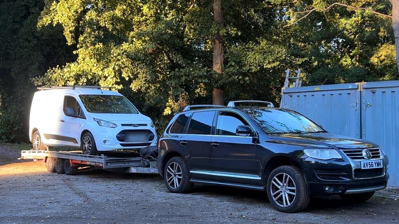 White Ford Transit Connect on the trailer at sunset